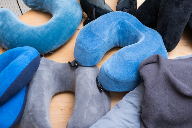 Multiple travel pillows piled together.